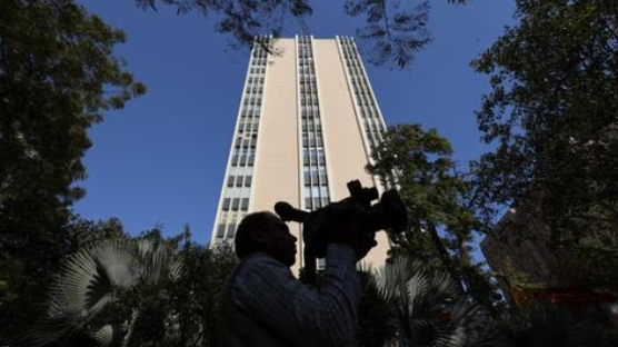 A cameraman works outside a building having BBC offices, where income tax officials are conducting a search, in New Delhi, India, February 14, 2023. REUTERS/Anushree Fadnavis