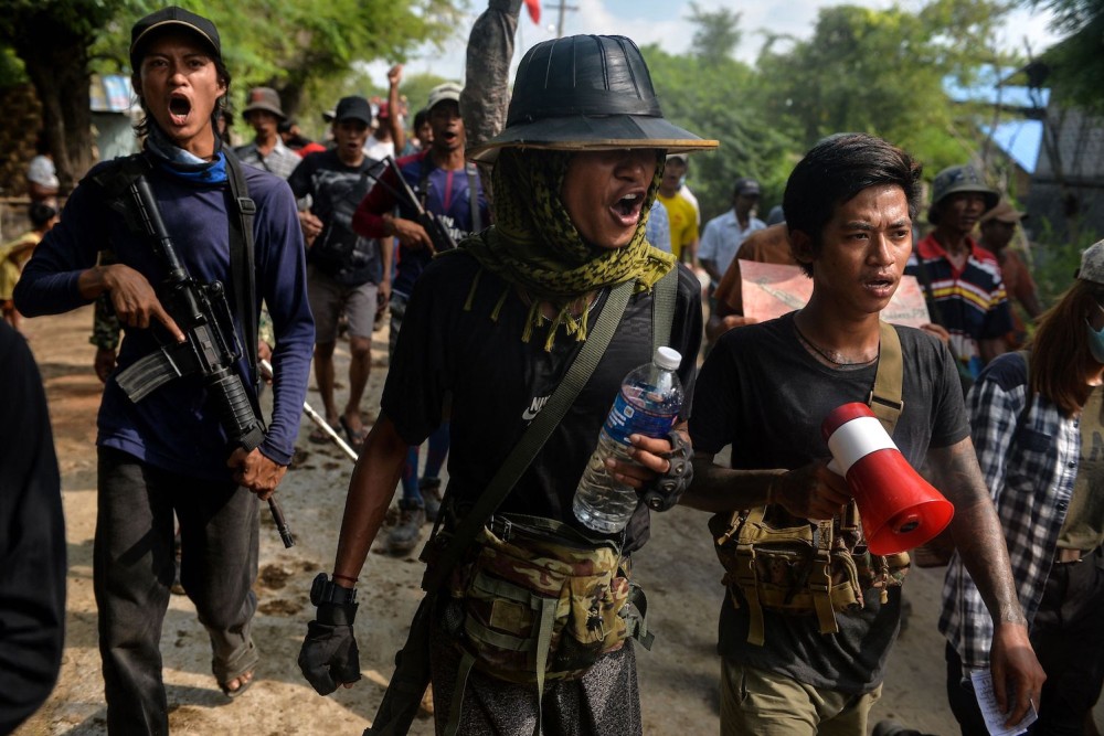 Democratic resistance fighters escort protesters during a demonstration against the military in Sagaing, Myanmar, on Sept. 7. STR/AFP VIA GETTY IMAGES